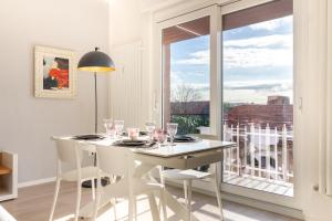 a dining room with a table and chairs and a window at La casa di Minù by Houset in Monza +17 photos