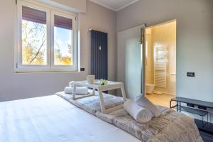 a bedroom with a bed with a table and a window at La casa di Minù by Houset in Monza