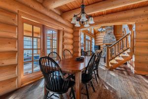 una sala da pranzo con tavolo e sedie in legno di Fiddler Lake Resort - Bear 25 a Mille-Isles