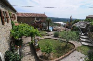 an outdoor garden with trees and a house at Villa Casa Sarina in Brdo