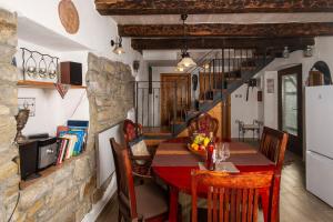 a kitchen and dining room with a table and chairs at Villa Casa Sarina in Brdo