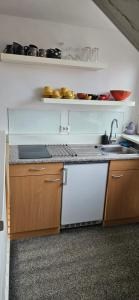 a kitchen with a sink and a counter top at Deluxe STUDIO-appartement Heemstede Zandvoort in Heemstede +11 photos