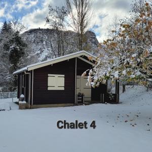 SauratLES CHALETS de MONTORGUEIL的雪地里一间小屋，上面写着“粉笔”字样