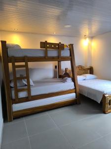 a room with two bunk beds in a room at Hotel coral Issa in Bahía Solano