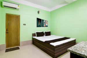 Ένα ή περισσότερα κρεβάτια σε δωμάτιο στο Hotel O Sampad