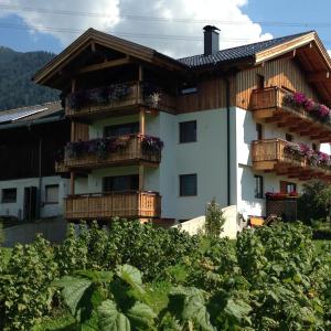 a building with balconies and plants in front of it at Bucherhof in Obsteig