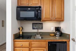 a kitchen with a sink and a microwave at Timbers Studio 14 with Wintergreen Advantage in Wintergreen