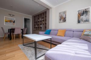 a living room with a purple couch and a table at Sanja & Mirza Apartments - Old Town Sarajevo in Sarajevo