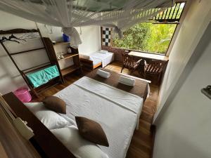 a bedroom with two beds and a large window at Verdant Hill Villa in Tangalle +123 photos