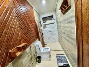 a small bathroom with a toilet and a shower at Mnazi Dream House in Kiwengwa +88 photos