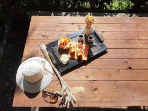 a picnic table with a hat and a tray of food at Holidays Catassino in Urbino