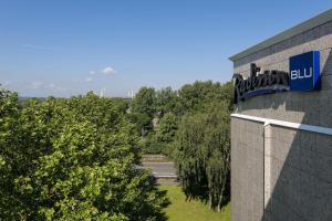 a building with a sign on the side of it at Radisson Blu Hotel Dortmund in Dortmund