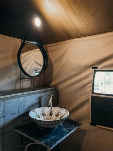 a bathroom with a sink and a mirror at Streaming Offline Karjat - Premium Tent Stay with Private Plunge Pool in Jambrung 