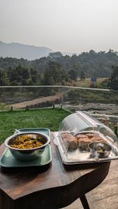 a table with a tray of food and a bowl of food at Streaming Offline Karjat - Premium Tent Stay with Private Plunge Pool in Jambrung 
