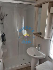 a bathroom with a shower and a sink at Hikers Den, Brigham, Cockermouth, Cumbria in Cockermouth