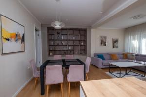 a living room with a table and chairs and a couch at Sanja & Mirza Apartments - Old Town Sarajevo in Sarajevo