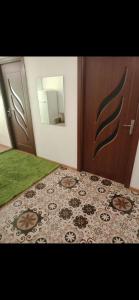 a bedroom with a bed and a wooden door at Apartament LUXURY Cluj in Floreşti