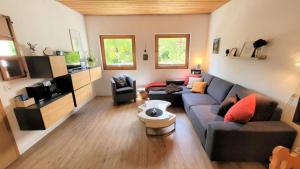 a living room with a couch and a table at Yvonne Mayer in Scuol
