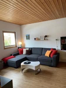 a living room with a couch and a coffee table at Yvonne Mayer in Scuol
