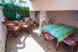 a patio with a table and chairs and a table and a table and chairsktop at Fewo Superior in Grebaštica +6 photos