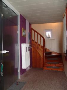 a room with a staircase and a wooden door at Uns Oellernhuus in Ostseebad Karlshagen