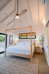 a bedroom with a canopy bed in a room at Tesoro en la Colina in Palmetto Bay