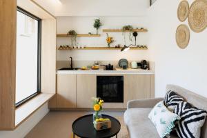 a living room with a couch and a table at Suite Cigale Jaune avec terrasse et piscine à Antibes in Antibes