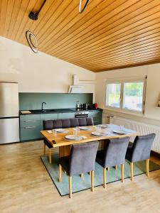 a kitchen with a wooden ceiling and a table and chairs at Haus Ambiente - 4 Fewos in Bad Säckingen