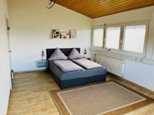 a bedroom with a bed in the corner of a room at Haus Ambiente - 4 Fewos in Bad Säckingen
