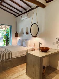 Ένα ή περισσότερα κρεβάτια σε δωμάτιο στο Pousada Quintal Caraíva +70 φωτογραφίες