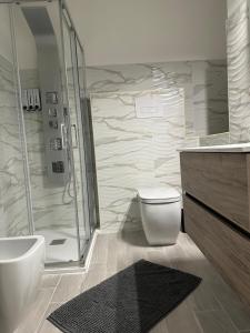a bathroom with a shower and a toilet and a sink at Residenza Aurora in Isernia