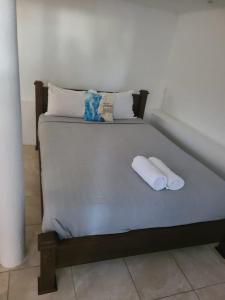 a bed with two pillows and two towels on it at Blue Sail Apartments in Simpson Bay +169 photos