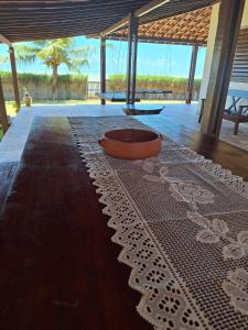 a table with a bowl on top of a floor at Espaço Varanda e Mar in São Miguel do Gostoso +55 photos