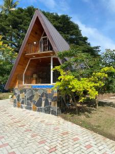 a small house with a gambrel roof at Grant Luxury Cabanas in Kandy