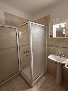 a bathroom with a shower and a sink at Babela 2 in Concordia +29 photos