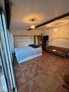 a bedroom with a bed and a tiled floor at Studio with pool and quiet, non-shared garden, 1 lit double in Gardanne