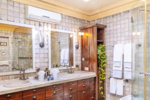 a bathroom with two sinks and a large mirror at Luxury Stay Villa de Caesarea in Caesarea +13 photos