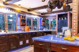 a large kitchen with blue counter tops and windows at Luxury Stay Villa de Caesarea in Caesarea
