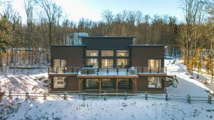 a house in the winter with snow on the ground at Chalet Grandview in Bel Air in La Conception