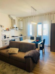 a living room with a couch and a kitchen with a table at Treviso Home Chic in Treviso