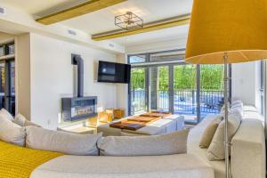 a living room with a couch and a tv at Verbier Condo in Tremblant with Mountain Views - 105 Verbier in Mont-Tremblant