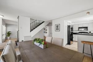 a kitchen and living room with a table and chairs at Ocean Breeze Getaway - Solana Beach Condo in Solana Beach