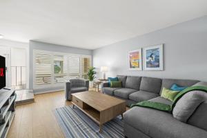 a living room with a couch and a table at Ocean Breeze Getaway - Solana Beach Condo in Solana Beach