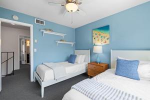 a bedroom with two beds and a blue wall at Ocean Breeze Getaway - Solana Beach Condo in Solana Beach +69 photos