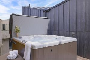a bath tub sitting on top of a building at Luxury 4BR with Hot Tub Mtn Views 10Min Walk to DT in Canmore