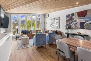 a living room with a table and a couch at Luxury 4BR with Hot Tub Mtn Views 10Min Walk to DT in Canmore
