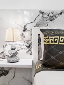 a bedroom with a bed with a table with a lamp at Travelers Nest in Safi