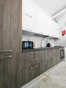 a kitchen with wooden cabinets and a microwave at Travelers Nest in Safi +13 photos