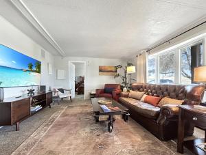 a living room with a leather couch and a table at Walker Ridge in Montrose