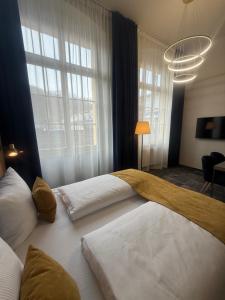 a bedroom with two beds and a large window at H24 Parkhotel Thale in Thale